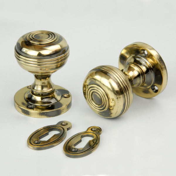 Regency Bloxwich Solid Antique Brass Door Knobs on a Rose with Escutcheons