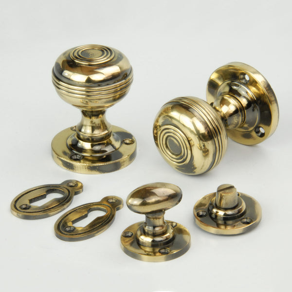 Regency Bloxwich Solid Antique Brass Door Knobs Handles on a Round Rose