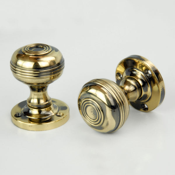 Regency Bloxwich Solid Antique Brass Door Knobs on a Rose with Escutcheons