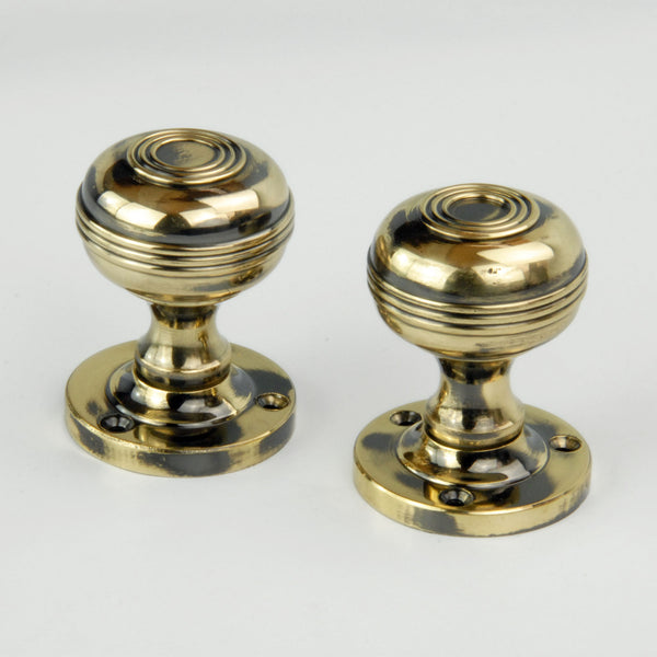 Regency Bloxwich Solid Antique Brass Door Knobs on a Rose with Escutcheons