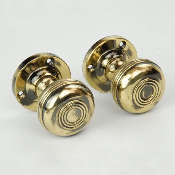 Regency Bloxwich Solid Antique Brass Door Knobs on a Rose with Escutcheons