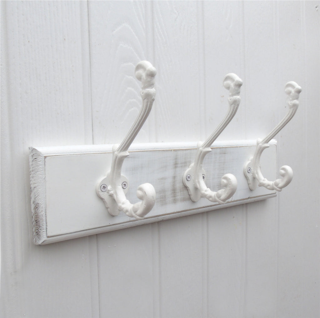A Shabby Chic Distressed Aged White Finish Ornate Wall Hook Coat Rack with 3 Cast Iron Hooks