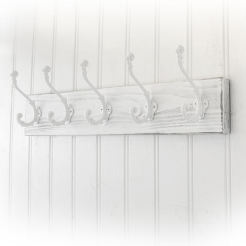 A Distressed White Wooden Coat Rack with 5 Cast Iron Ornate Hooks