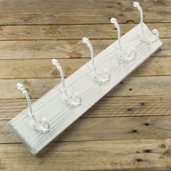 A Distressed White Wooden Coat Rack with 5 Cast Iron Ornate Hooks