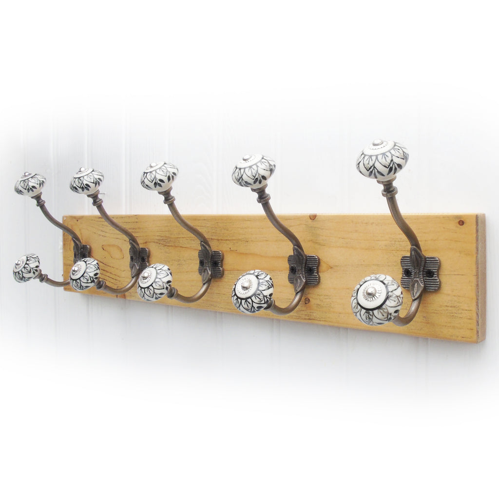 https://www.jonesandgrey.co.uk/cdn/shop/products/LightOakWoodenCoatRackwith5PaintedAntiqueBrassMetalHooks_1024x1024.jpg?v=1640272695