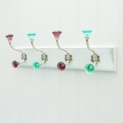 A White Wooden Coat Hook Rack with 4 Purple and Green Glass Hooks