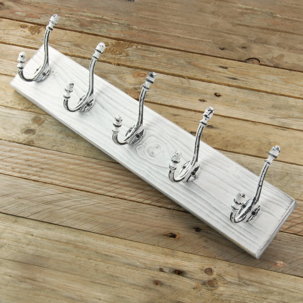 A Distressed White Wooden Coat Rack with 5 Cast Iron Hooks