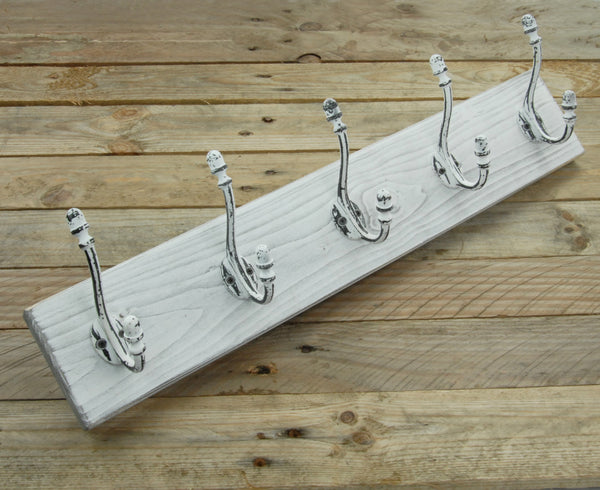 A Distressed White Wooden Coat Rack with 5 Cast Iron Hooks