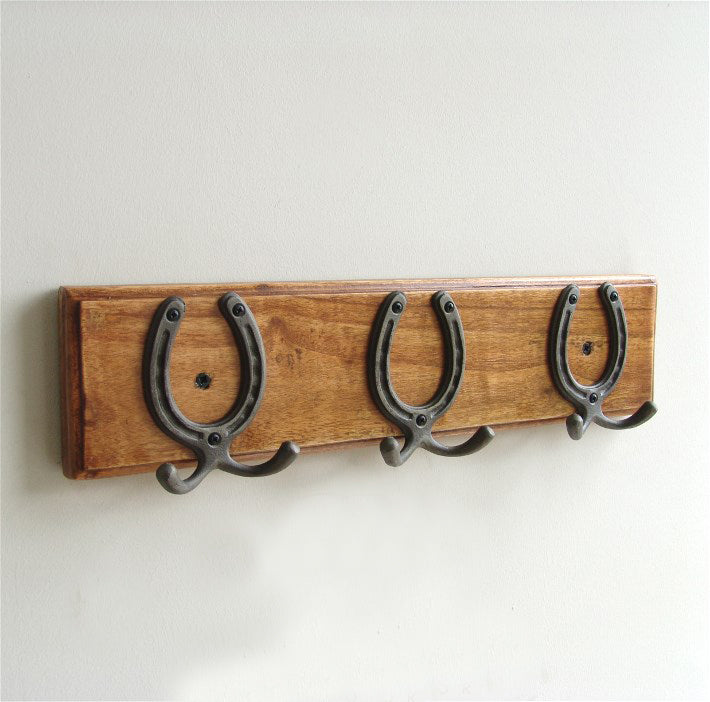 A Vintage Style Wooden Oak Colour Wall Coat Rack with Cast Iron Horseshoe Double Hooks