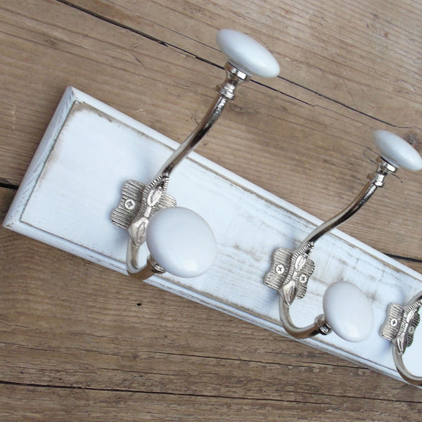 A Shabby Chic Distressed White Coat Hook Rack with 3 Cast Iron Hooks