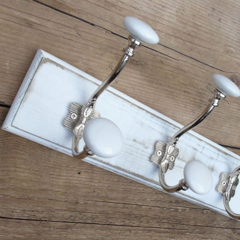 A Shabby Chic Distressed White Coat Hook Rack with 3 Cast Iron Hooks