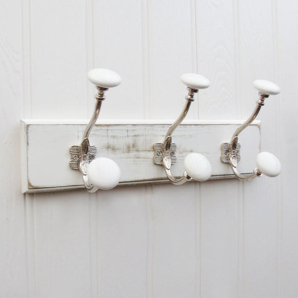 A Shabby Chic Distressed White Coat Hook Rack with 3 Cast Iron Hooks